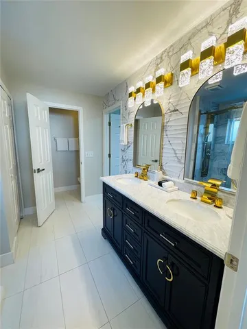 a bathroom with a sink vanity and a mirror