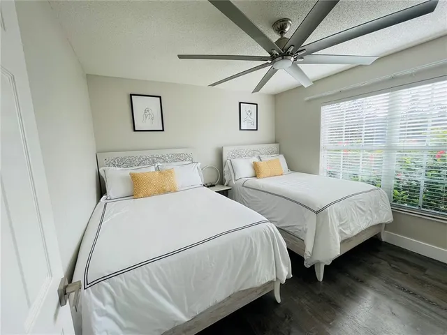 a bedroom with two beds and a chandelier