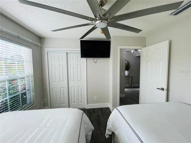 a bedroom with a bed and a chandelier