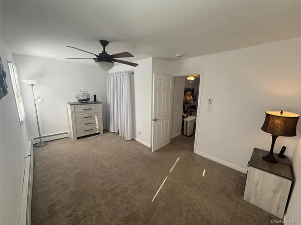 a view of a livingroom with furniture and a ceiling fan