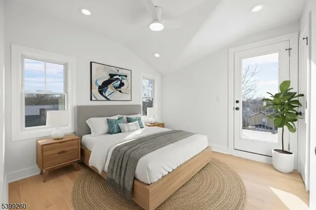 a bedroom with a large bed and a potted plant