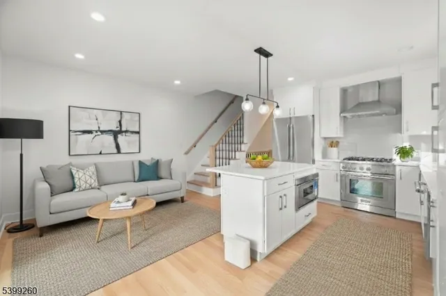 a kitchen with white cabinets and white appliances