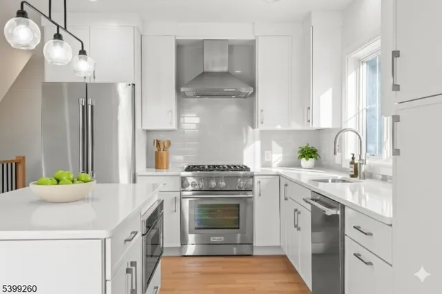 a kitchen with a stove sink and cabinets