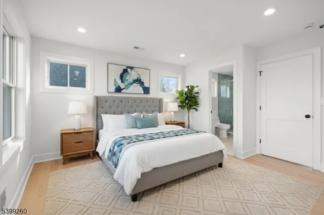 a bedroom with a large bed and a painting on the wall