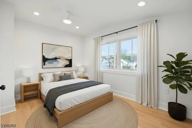 a bedroom with a bed and a large window