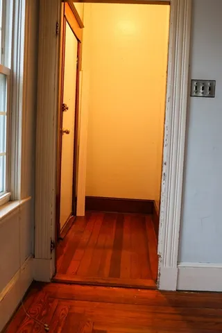 a view of a room with wooden floor and chair