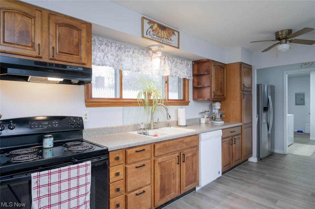 1165 Meadowview Road Kent, OH 44240 - Photo 9 of 40 Kitchen with black electric range, dishwasher, light hardwood / wood-style flooring, stainless steel fridge, and ceiling fan