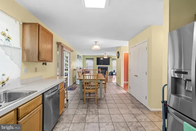 a kitchen with stainless steel appliances a refrigerator sink and cabinets