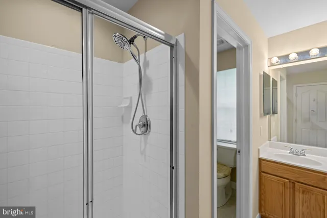 a bathroom with a shower and a mirror