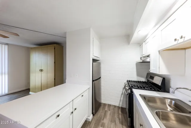 a utility room with sink dryer and washer