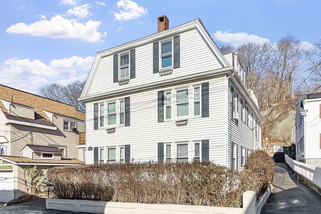 10 Oak Street, Unit 3 Gloucester, MA 01930 - Photo 2 of 24 a front view of a house with a yard
