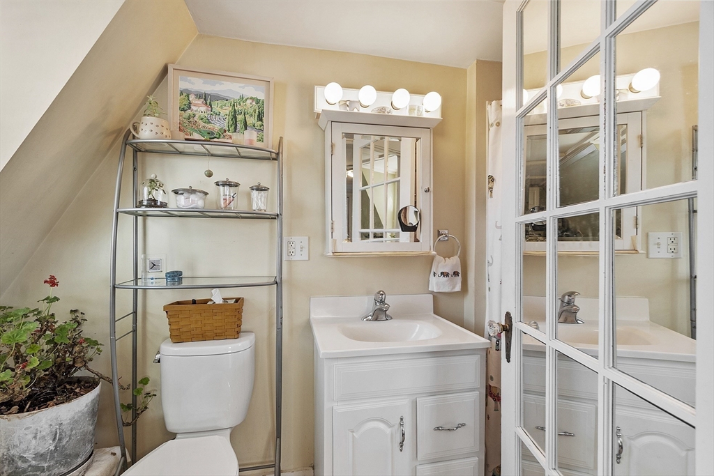 10 Oak Street, Unit 3 Gloucester, MA 01930 - Photo 22 of 24 a bathroom with a toilet a sink and a large mirror