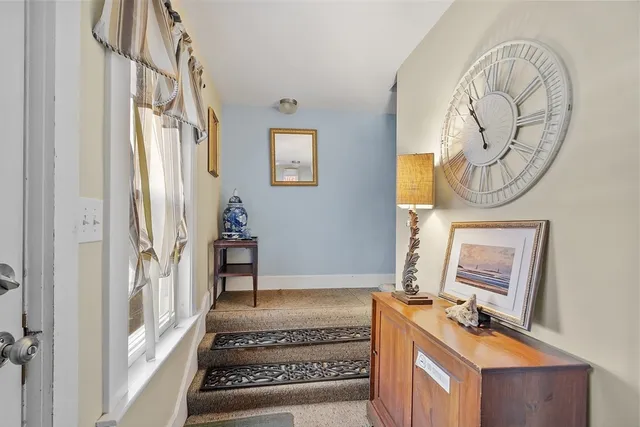 a bathroom with a mirror a sink and a window