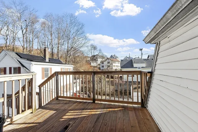 a view of a balcony with wooden floor and fence