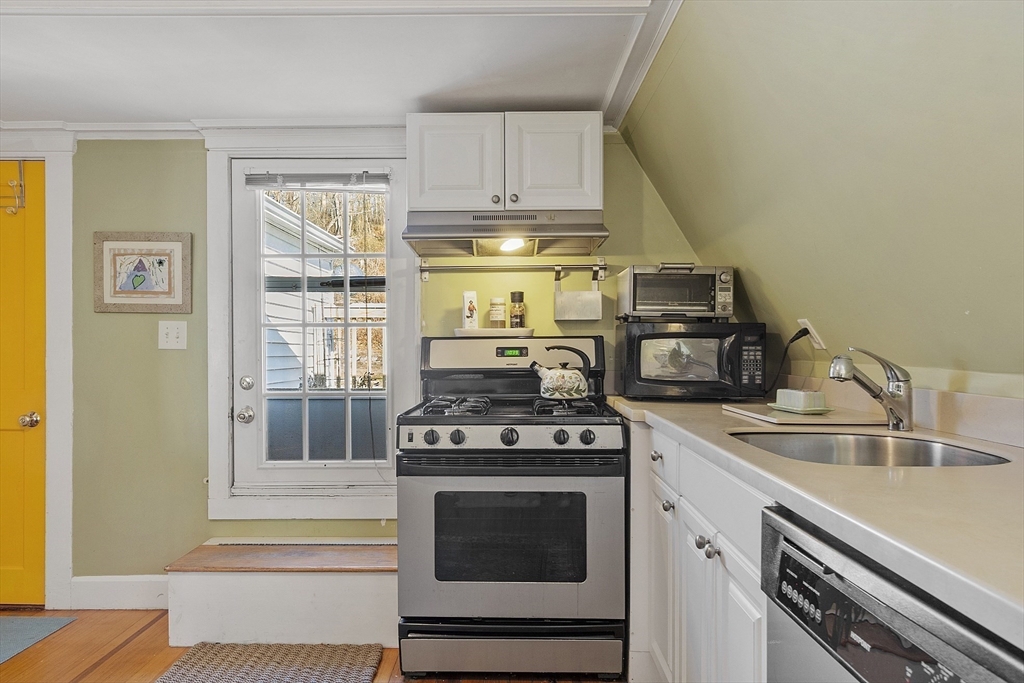 10 Oak Street, Unit 3 Gloucester, MA 01930 - Photo 10 of 24 a kitchen with stove top oven and cabinets