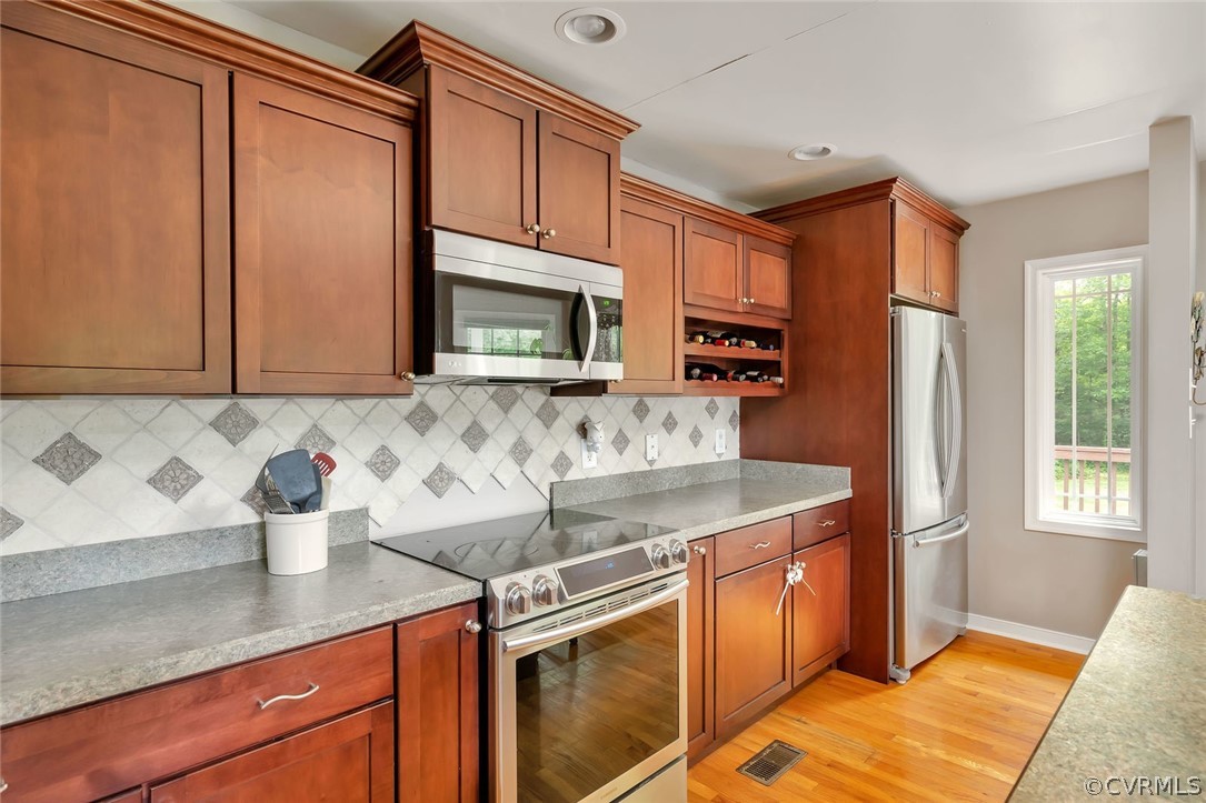 14498 Scotts Lane Carson, VA 23830 - Photo 16 of 44 a kitchen with stainless steel appliances granite countertop a sink stove microwave and refrigerator