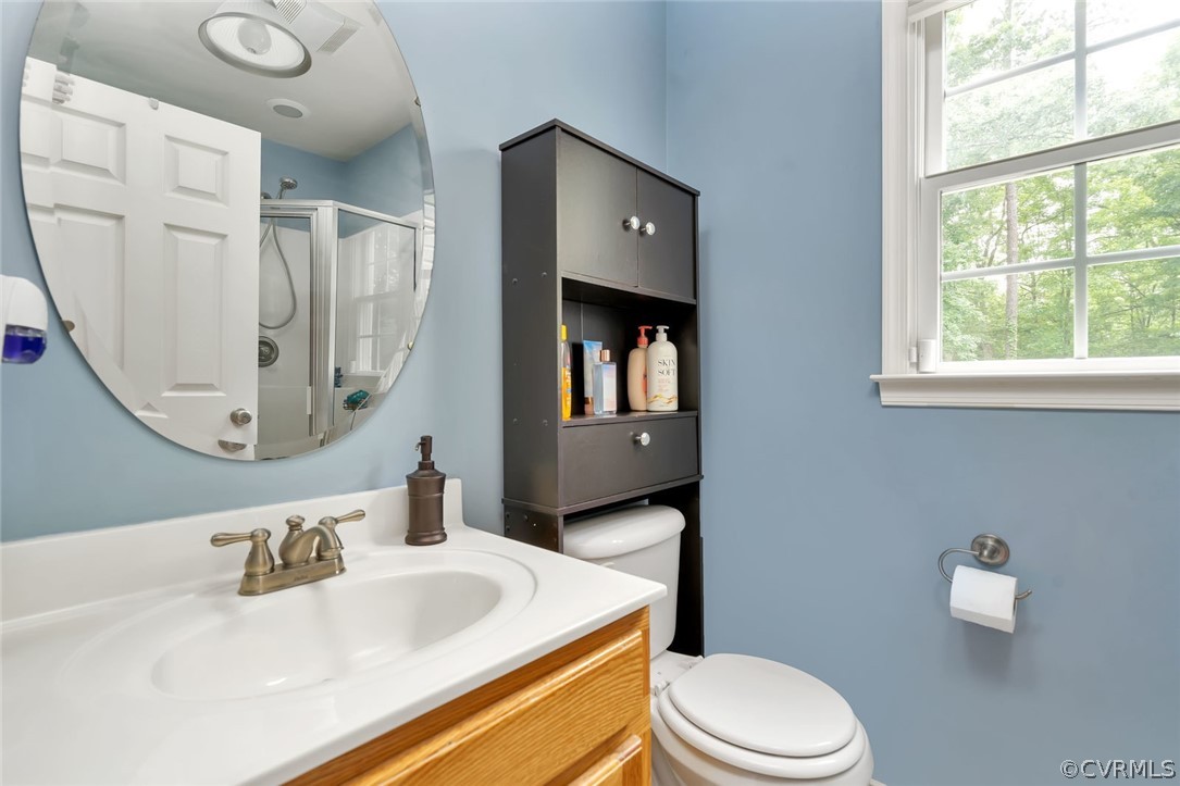 14498 Scotts Lane Carson, VA 23830 - Photo 21 of 44 a bathroom with a sink vanity mirror and toilet