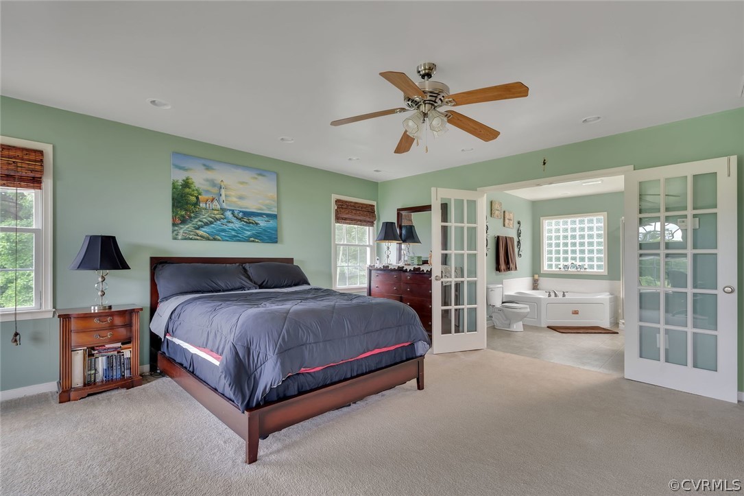 14498 Scotts Lane Carson, VA 23830 - Photo 28 of 44 a spacious bedroom with a bed a couch and large window