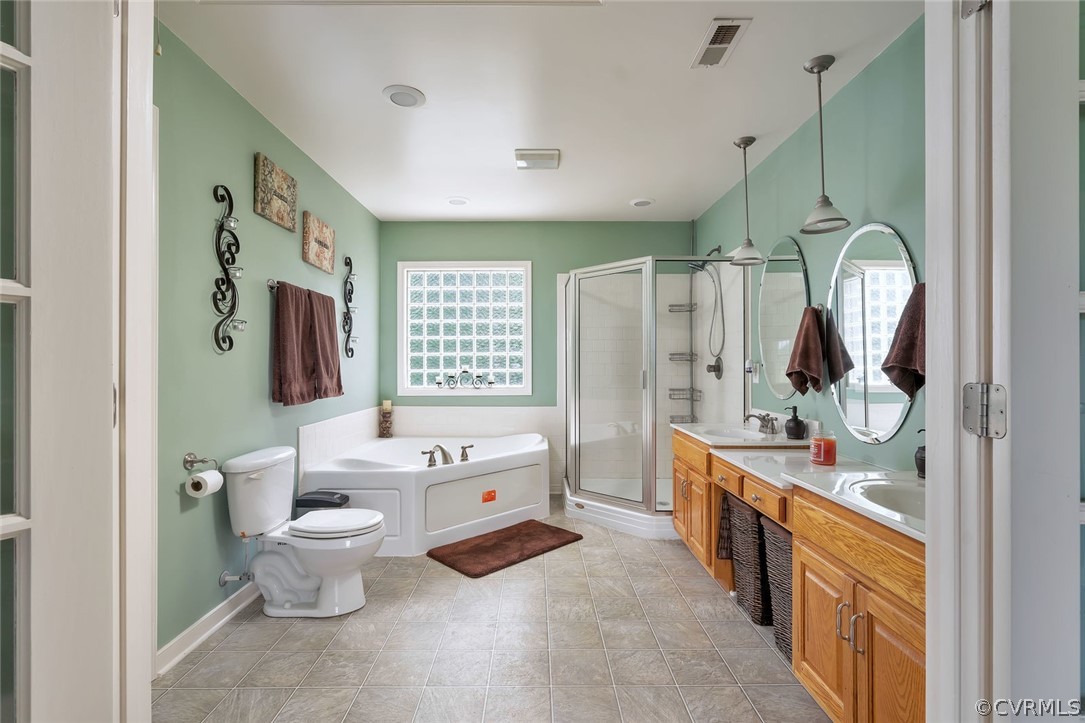 14498 Scotts Lane Carson, VA 23830 - Photo 30 of 44 a bathroom with a double vanity sink toilet mirror and tub