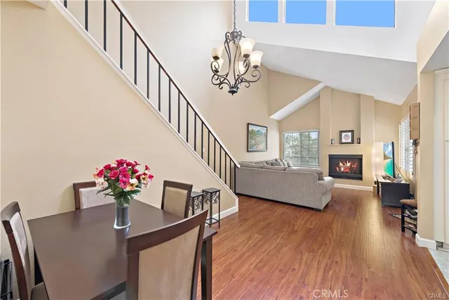 a dining room with wooden floor and stairs