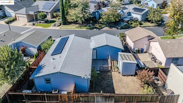 an aerial view of residential houses with outdoor space and parking