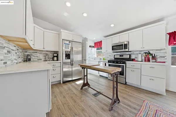 a kitchen with a sink cabinets and wooden floor