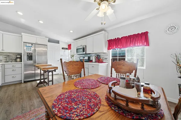 a living room with furniture a rug and kitchen view
