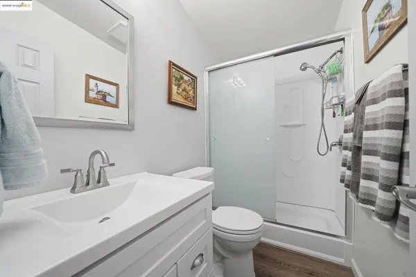 a bathroom with a sink a toilet and shower