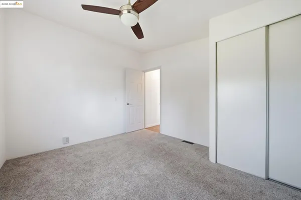 a view of a room with a ceiling fan