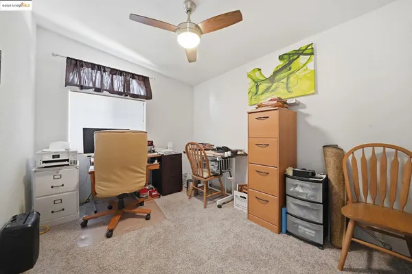 a view of a kitchen with refrigerator and window