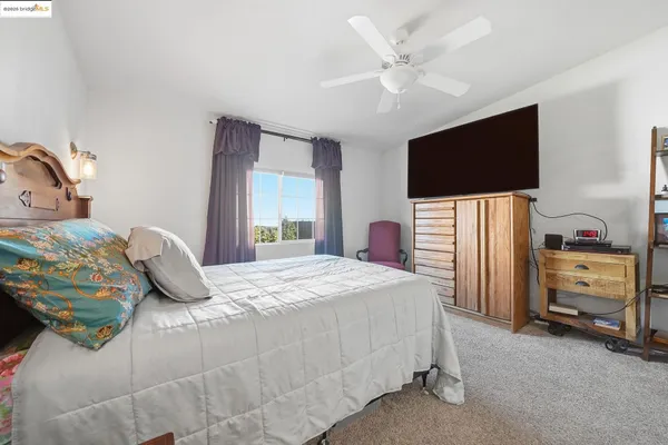 a bed room with a bed and a chair