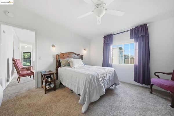 a spacious bedroom with a bed and a lamp