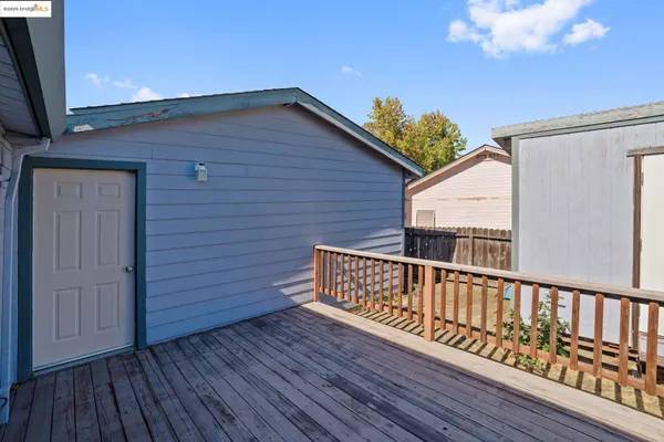a view of backyard with a deck and wooden floor