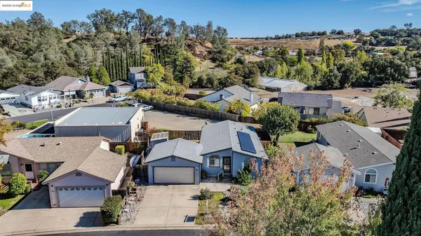 an aerial view of multiple houses with yard
