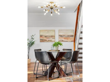 a view of a dining room with furniture and a potted plant