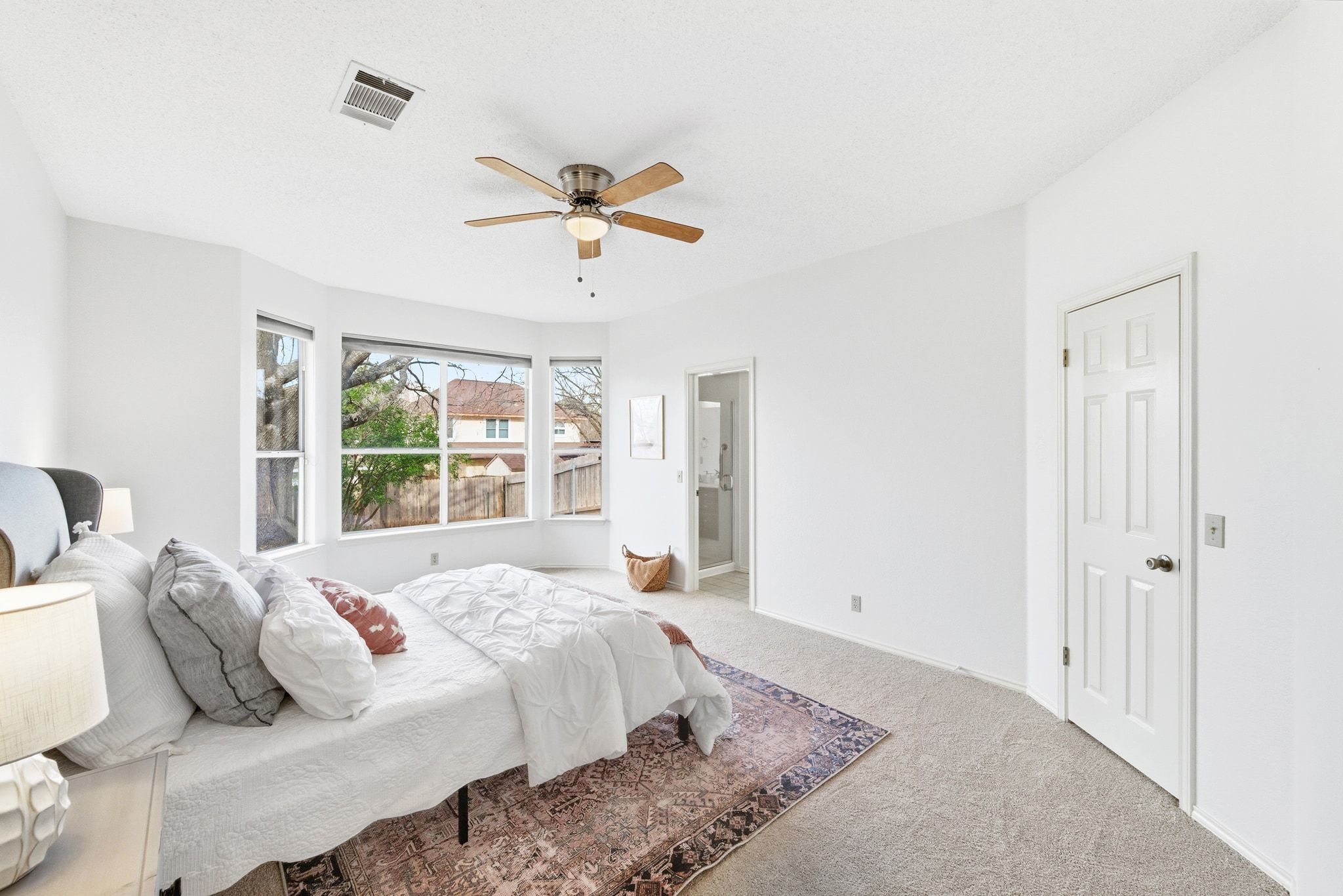 6412 Sailing Breeze Trail Austin, TX 78744 - Photo 11 of 18 a bedroom with a bed ceiling fan and a window