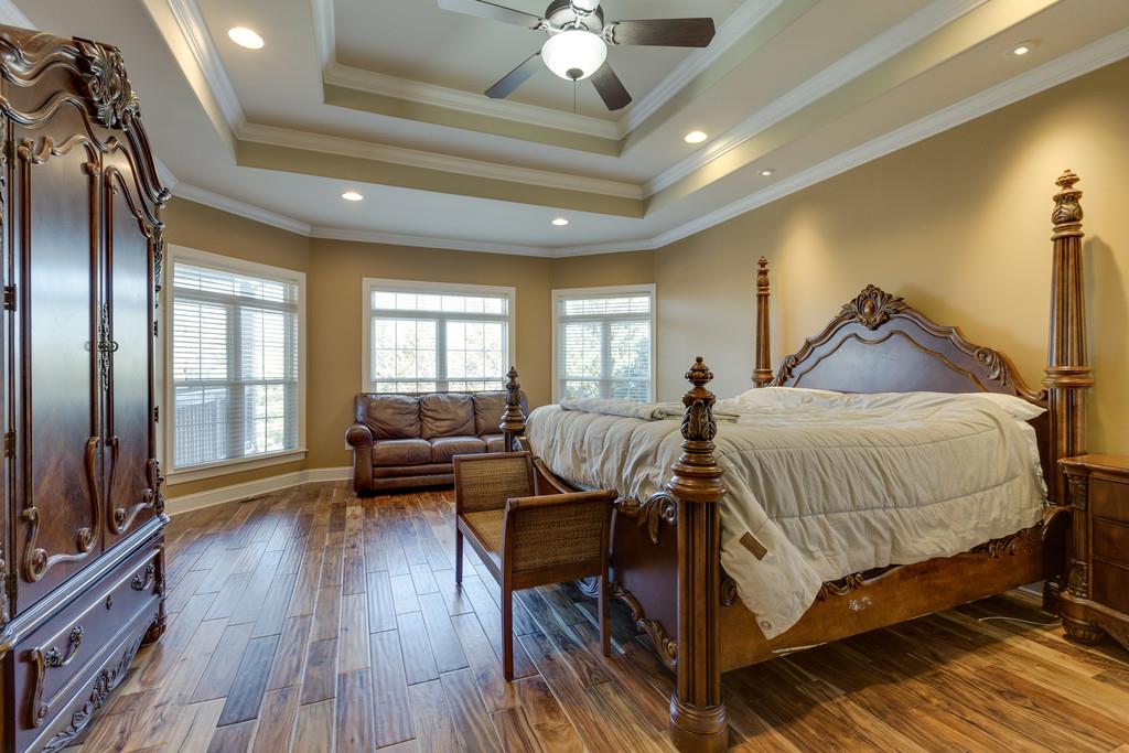 1206 White Rock Road Spring Hill, TN 37174 - Photo 11 of 30 a spacious bedroom with a bed and wooden floor