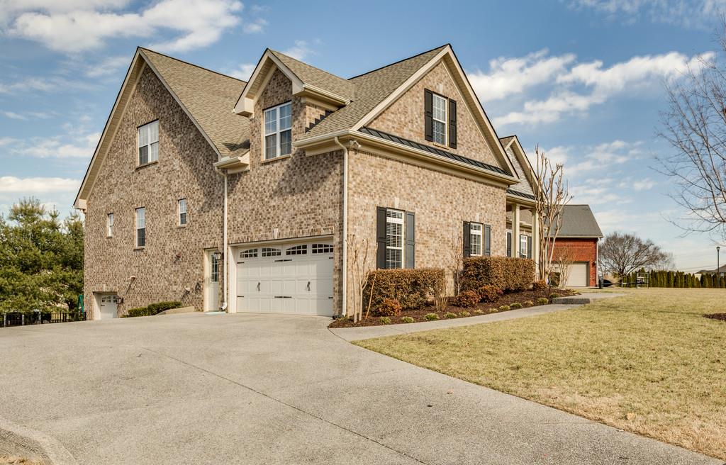 1206 White Rock Road Spring Hill, TN 37174 - Photo 2 of 30 a view of a white house with large windows next to a road
