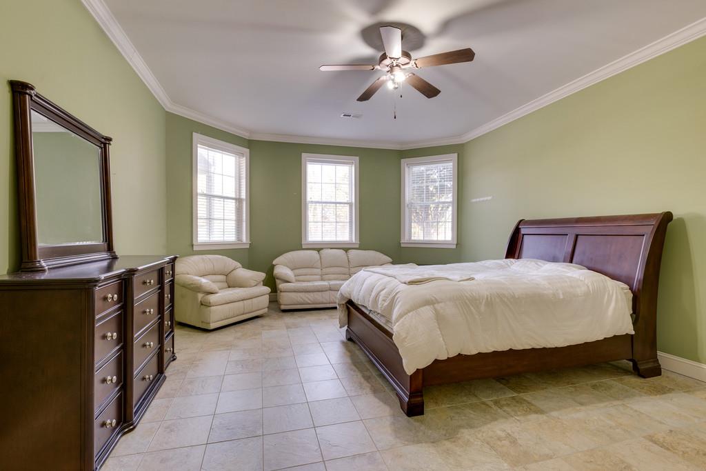 1206 White Rock Road Spring Hill, TN 37174 - Photo 24 of 30 a spacious bedroom with a bed and a chandelier