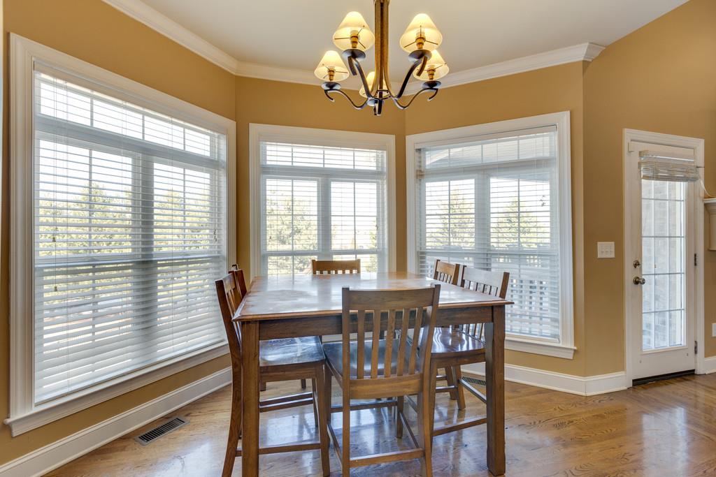 1206 White Rock Road Spring Hill, TN 37174 - Photo 8 of 30 a view of a dining room with furniture wooden floor and chandelier