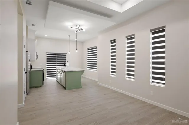 a kitchen with cabinets and wooden floor