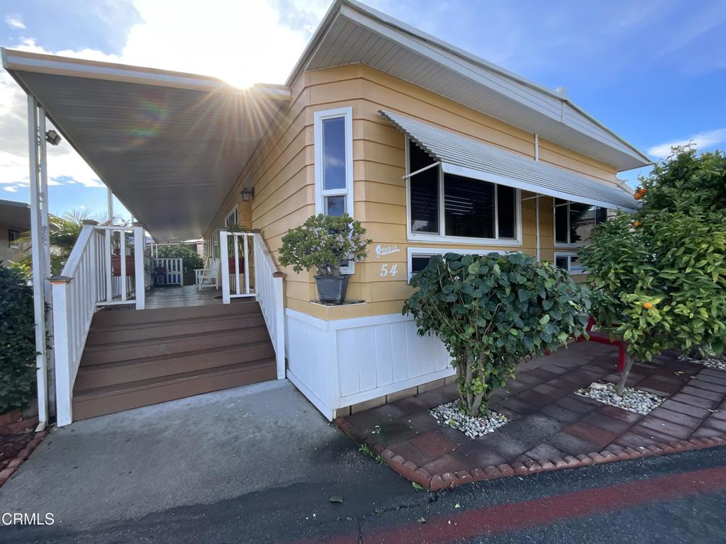 15433 West Telegraph Road, Unit 54 Santa Paula, CA 93060 - Photo 1 of 25 a front view of a house with garden