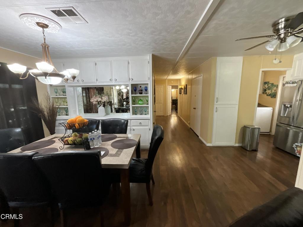 15433 West Telegraph Road, Unit 54 Santa Paula, CA 93060 - Photo 15 of 25 a dining room with furniture and wooden floor