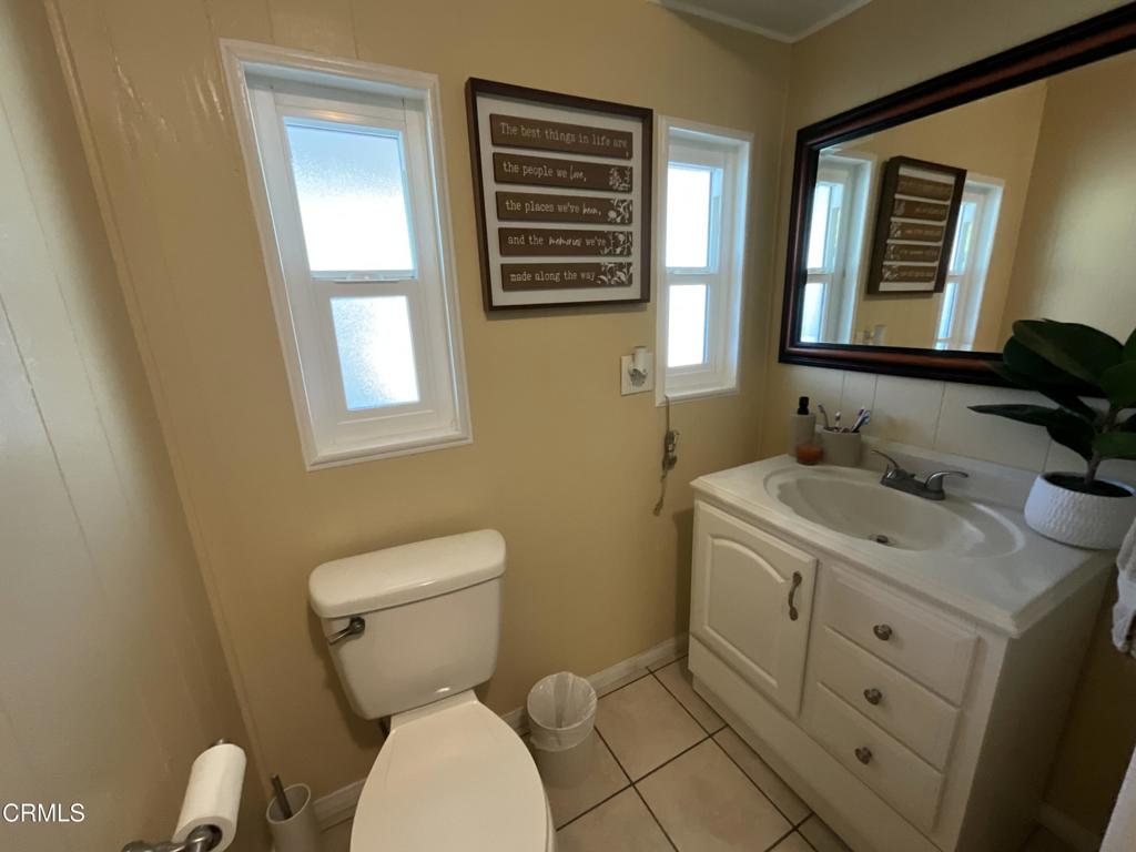 15433 West Telegraph Road, Unit 54 Santa Paula, CA 93060 - Photo 17 of 25 a bathroom with a toilet sink and mirror