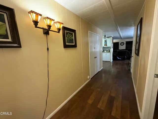 a view of a hallway view with wooden floor and staircase