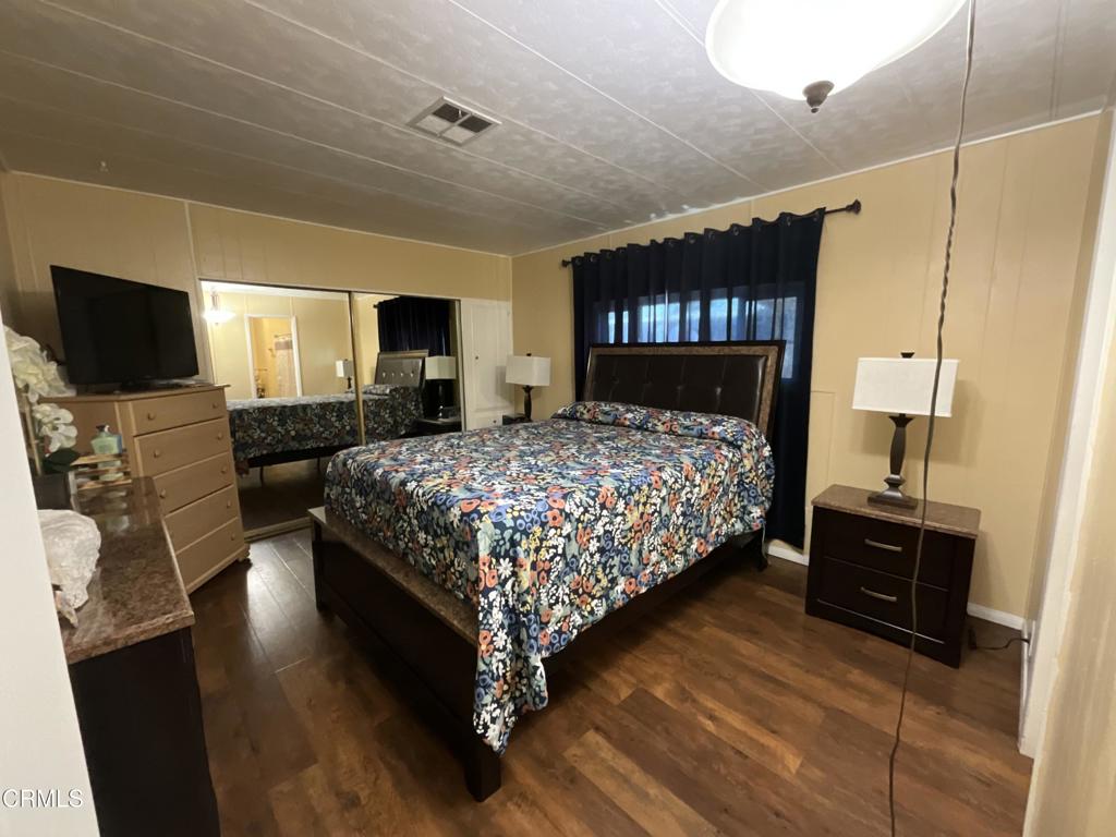 15433 West Telegraph Road, Unit 54 Santa Paula, CA 93060 - Photo 19 of 25 a bedroom with a bed a dresser and a flat screen tv