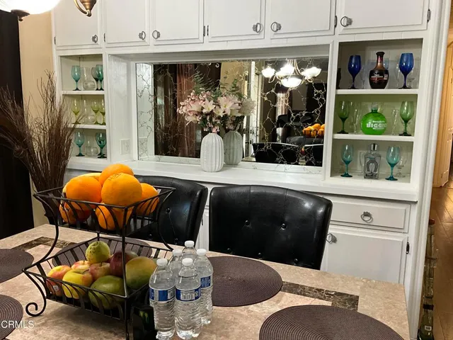 a living room with furniture and floor to ceiling window