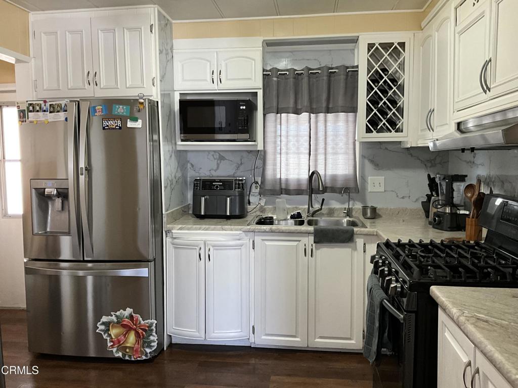 15433 West Telegraph Road, Unit 54 Santa Paula, CA 93060 - Photo 4 of 25 a kitchen with stainless steel appliances a refrigerator a sink and cabinets