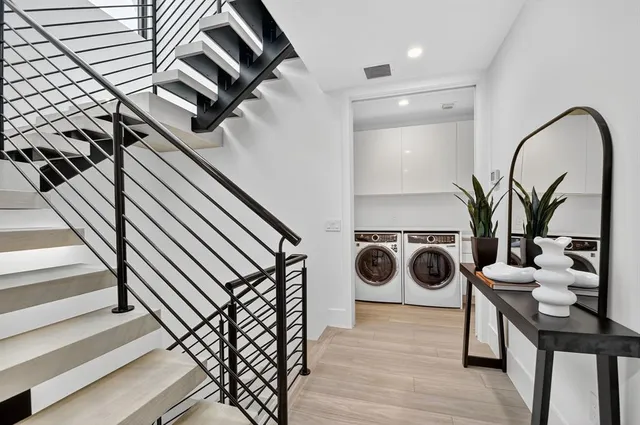 a living room with furniture and a mirror
