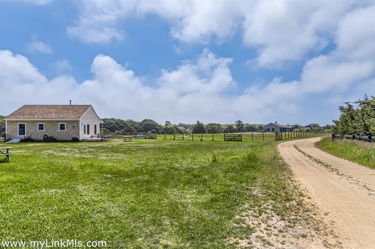104 Pond View Farm Road West Tisbury, MA 02568 - Photo 42 of 55 a view of a house with a big yard and a large trees